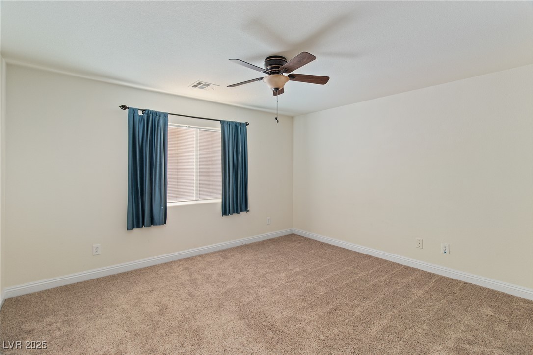 2715 Brinkley Manor Street Laughlin, NV 89029 - Photo 31 of 89 Upstairs has the Second Bedroom with light carpet and ceiling fan