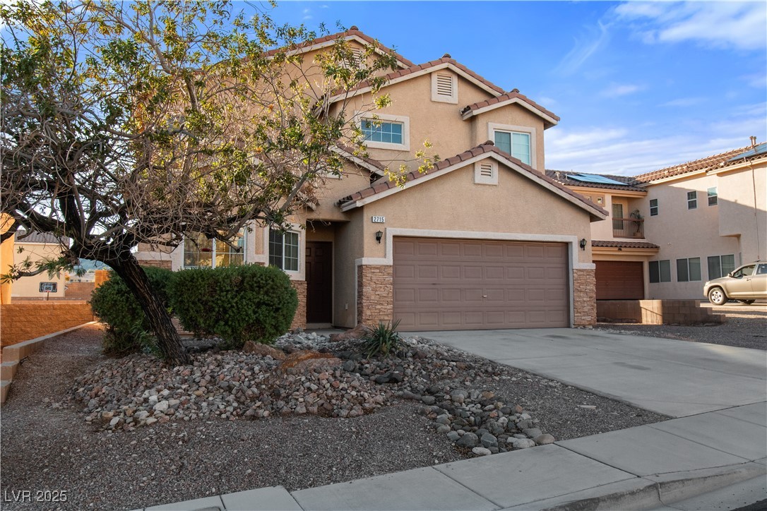 2715 Brinkley Manor Street Laughlin, NV 89029 - Photo 51 of 89 View of front of property with stone siding, driveway, stucco siding, a garage, and a tile roof