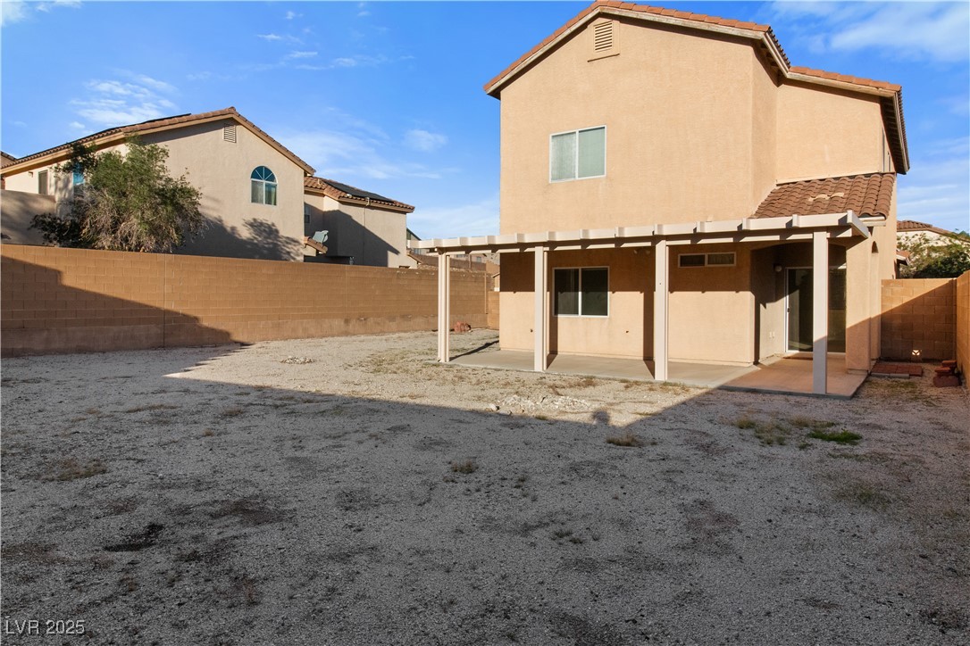 2715 Brinkley Manor Street Laughlin, NV 89029 - Photo 59 of 89 Rear view of property with stucco siding, a patio area, and a fenced backyard