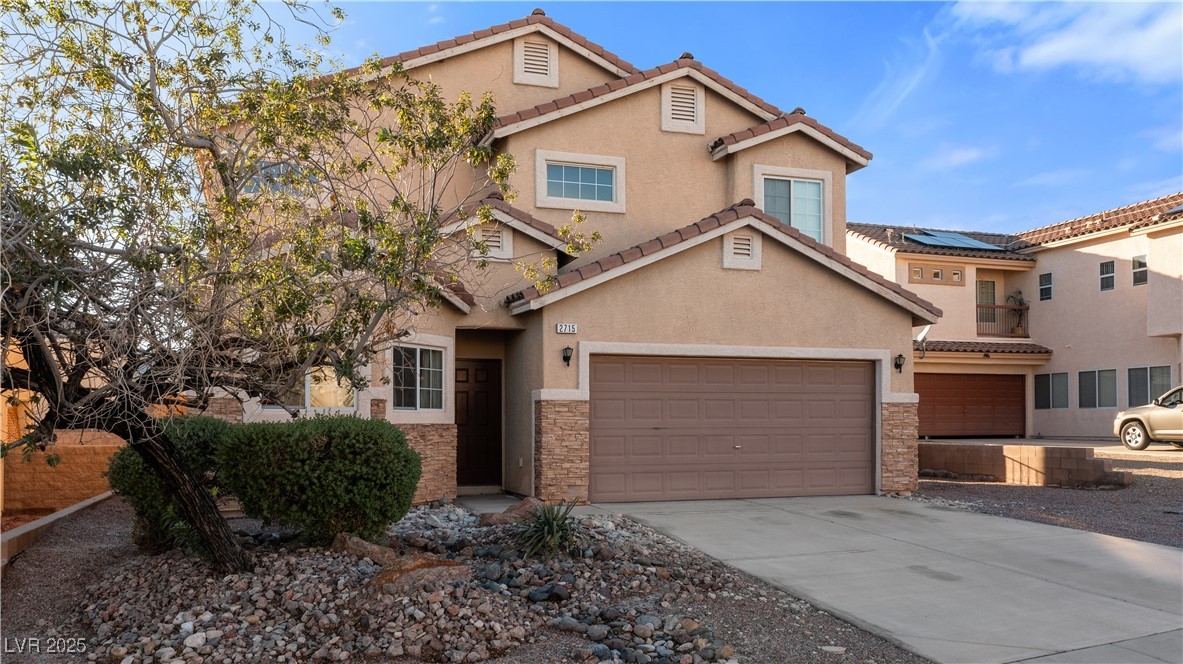 2715 Brinkley Manor Street Laughlin, NV 89029 - Photo 68 of 89 Mediterranean / spanish-style home featuring stone siding, stucco siding, concrete driveway, and a garage