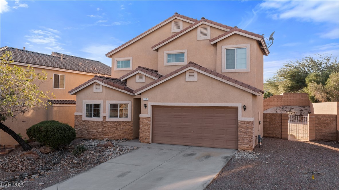 2715 Brinkley Manor Street Laughlin, NV 89029 - Photo 70 of 89 View of front of home featuring a gate, stone siding, stucco siding, and driveway