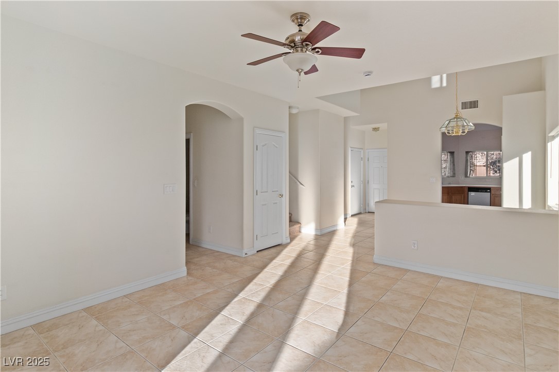 2715 Brinkley Manor Street Laughlin, NV 89029 - Photo 7 of 89 Living room with arched walkways, ceiling fan, and light tile patterned flooring
