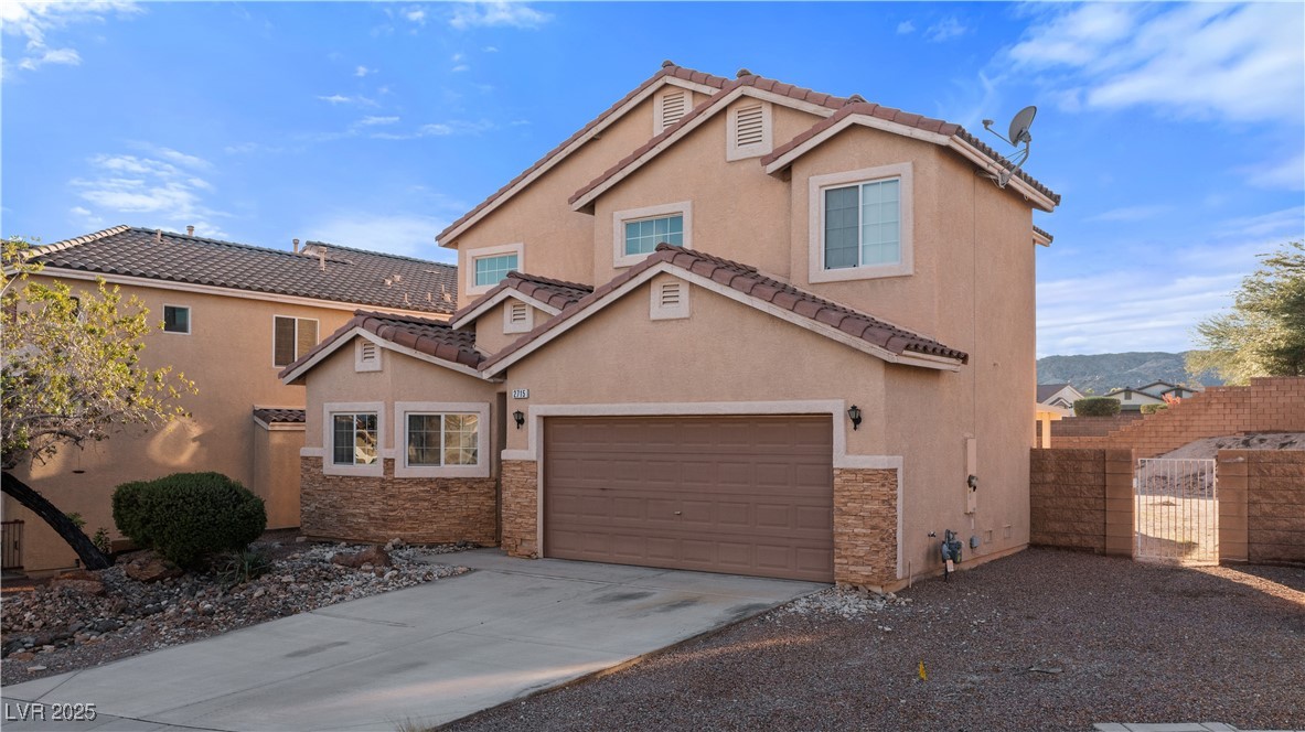 2715 Brinkley Manor Street Laughlin, NV 89029 - Photo 71 of 89 View of front of property featuring stone siding, stucco siding, a gate, and driveway