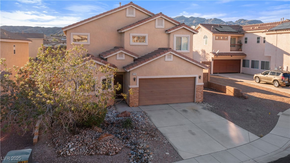 2715 Brinkley Manor Street Laughlin, NV 89029 - Photo 75 of 89 Mediterranean / spanish home with a mountain view, stucco siding, driveway, and stone siding