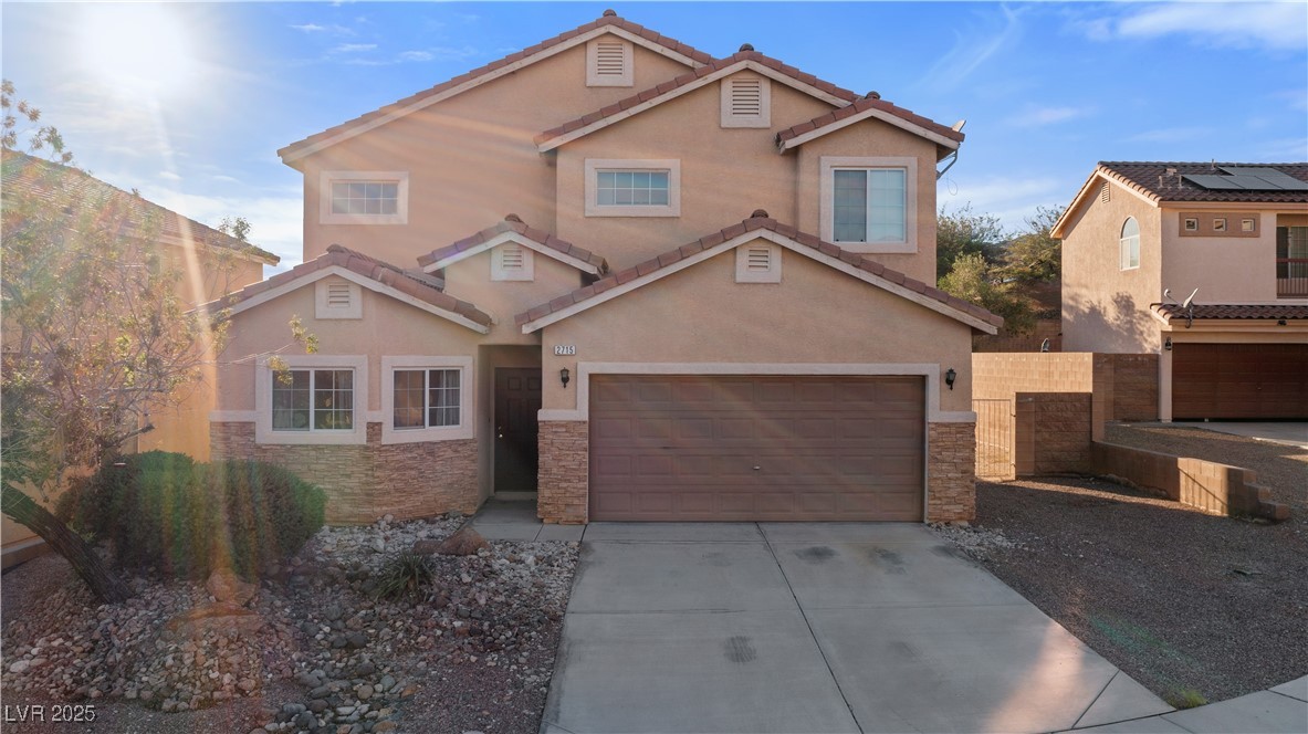 2715 Brinkley Manor Street Laughlin, NV 89029 - Photo 88 of 89 View of front of house featuring stone siding, stucco siding, concrete driveway, and a tiled roof
