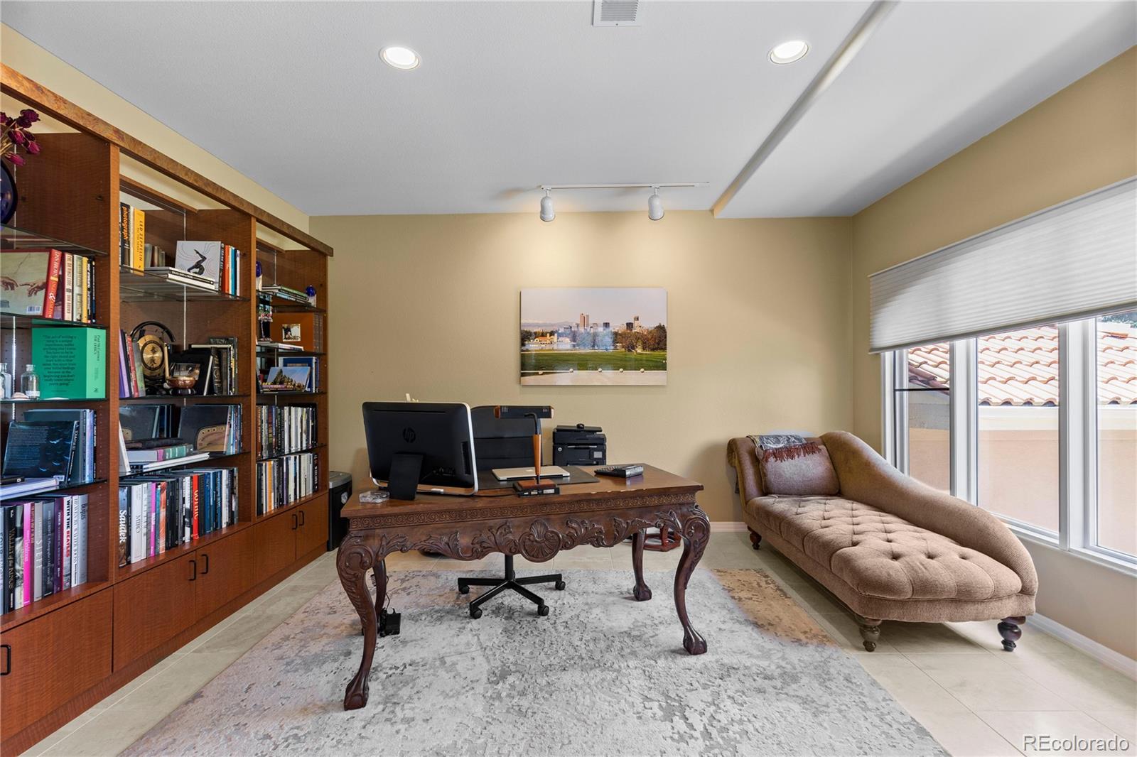 69 North Ranch Road Littleton, CO 80127 - Photo 12 of 50 a living room with furniture a bookshelf and a window