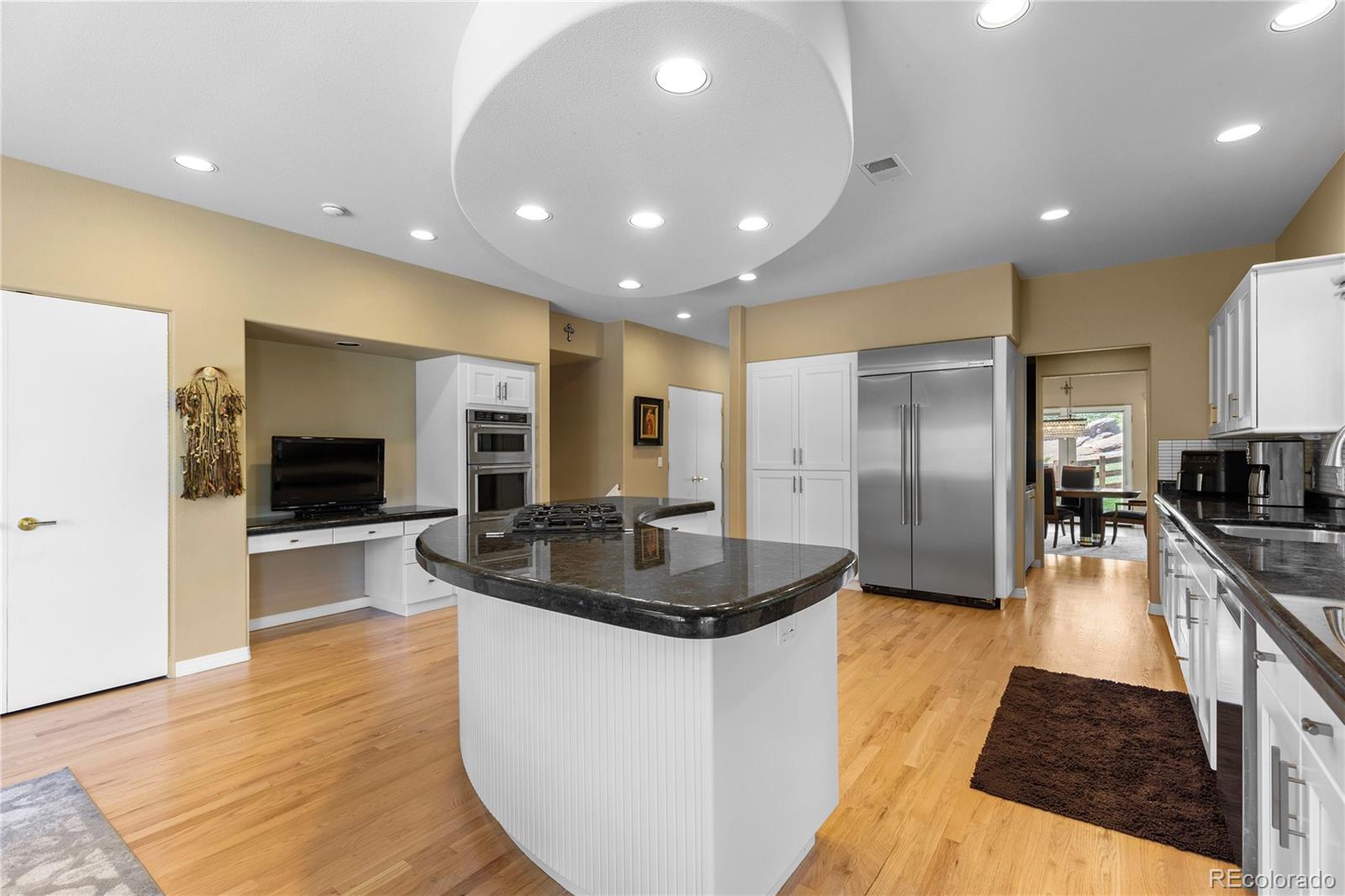 69 North Ranch Road Littleton, CO 80127 - Photo 16 of 50 a large kitchen with stainless steel appliances kitchen island granite countertop a large counter top stainless steel appliances and cabinets