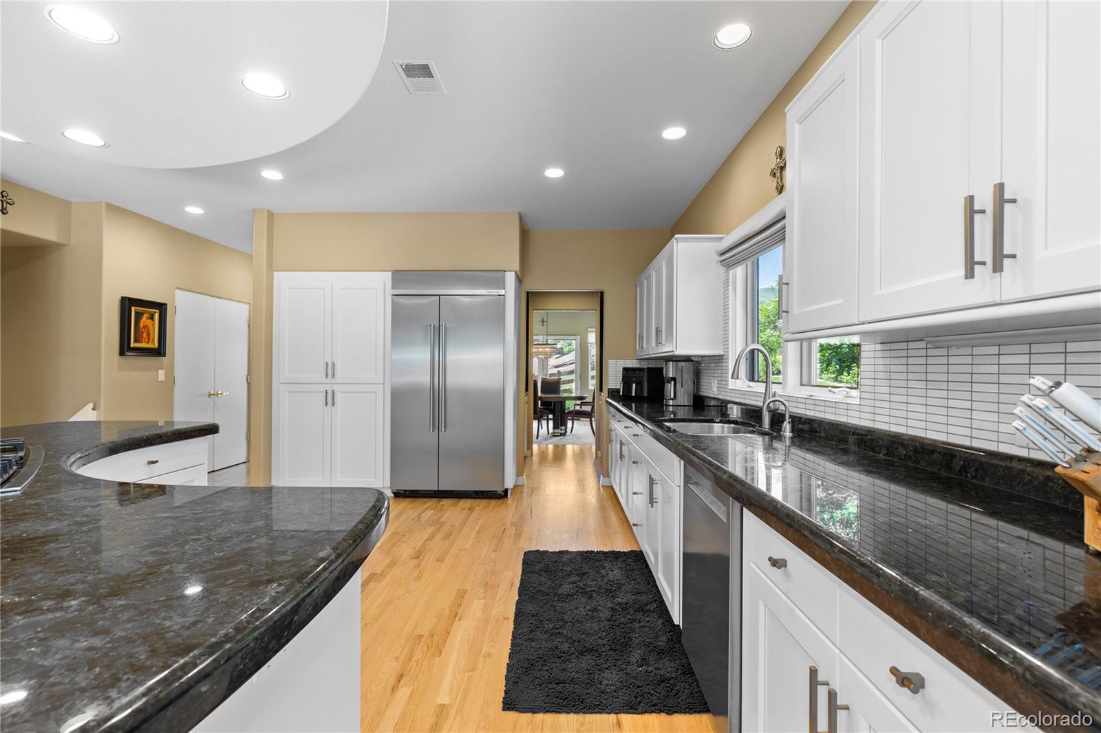 69 North Ranch Road Littleton, CO 80127 - Photo 17 of 50 a large kitchen with stainless steel appliances granite countertop a sink and a refrigerator