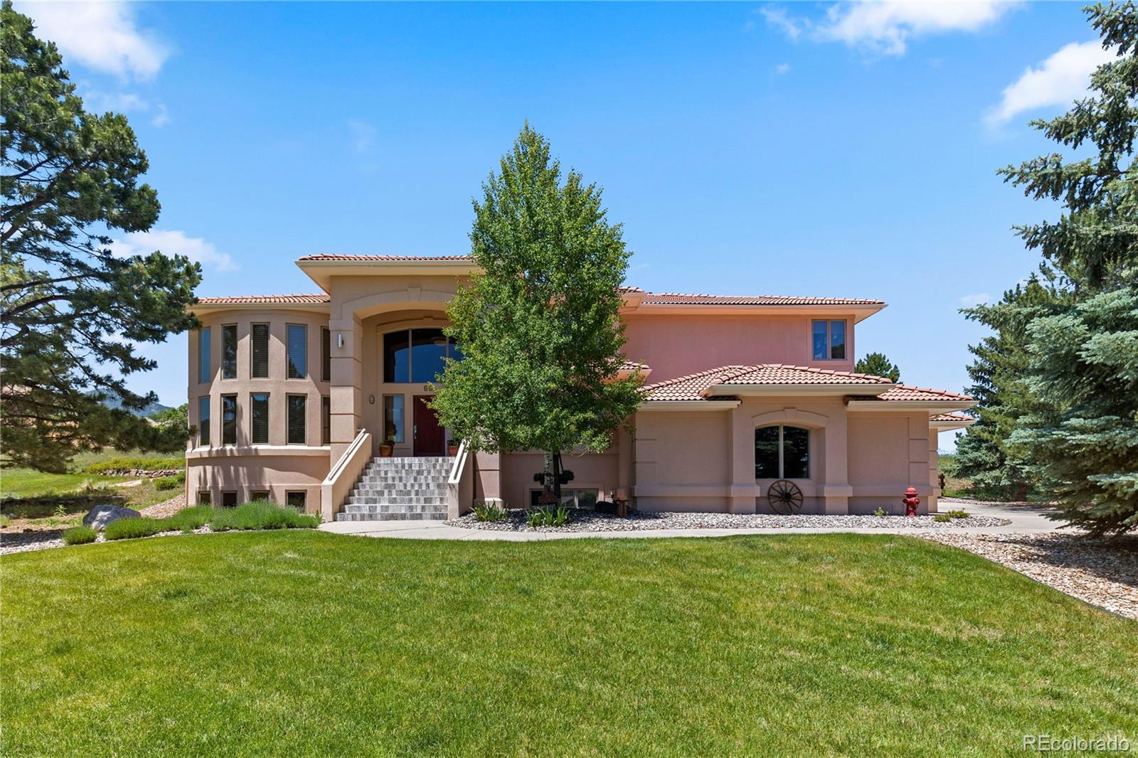 69 North Ranch Road Littleton, CO 80127 - Photo 2 of 50 a front view of a house with a yard