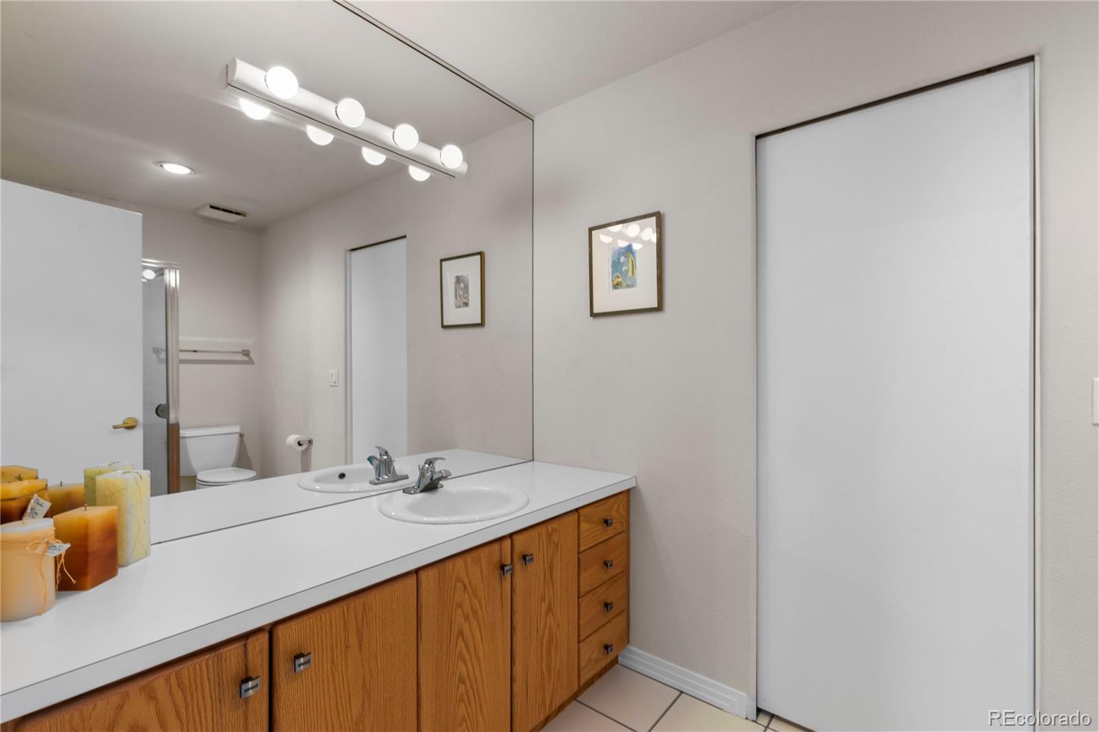 69 North Ranch Road Littleton, CO 80127 - Photo 32 of 50 a bathroom with a sink double vanity and a mirror
