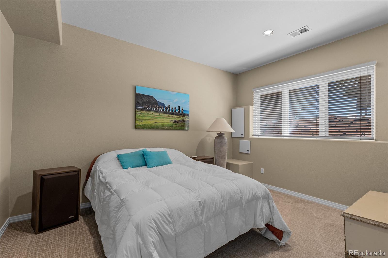 69 North Ranch Road Littleton, CO 80127 - Photo 35 of 50 a bedroom with a bed and painting on the wall