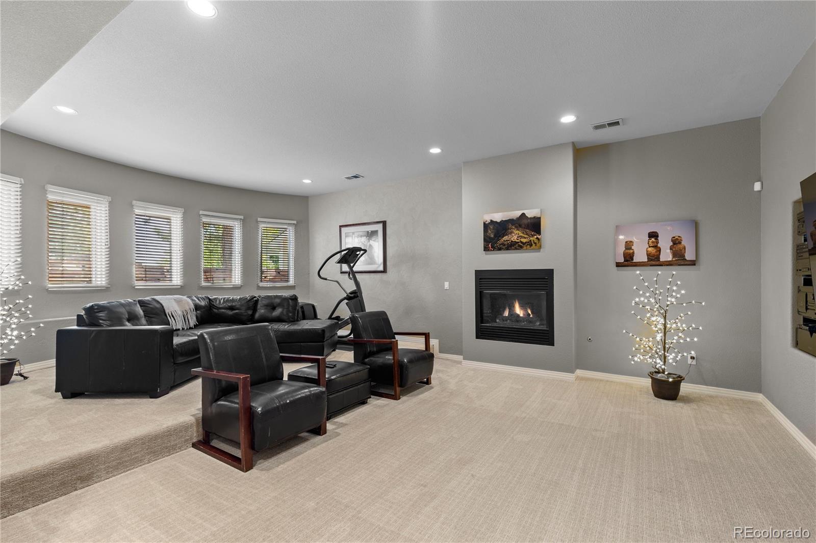 69 North Ranch Road Littleton, CO 80127 - Photo 42 of 50 a living room with furniture and a fireplace
