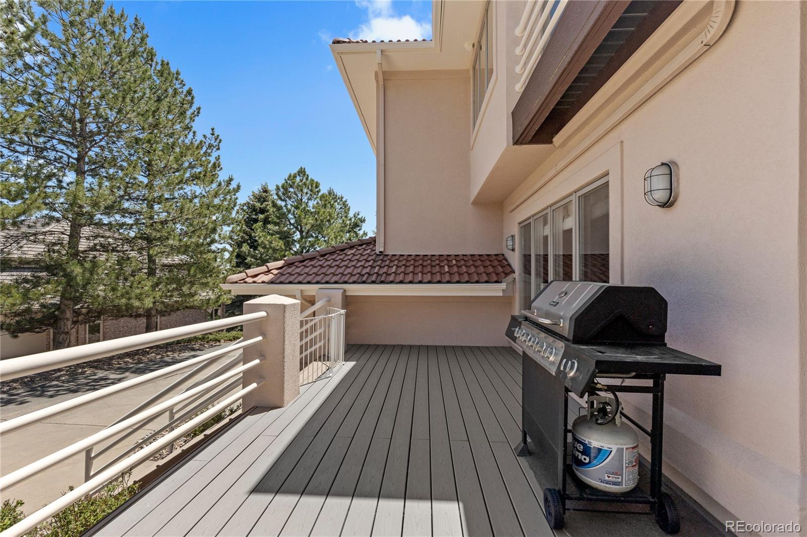 69 North Ranch Road Littleton, CO 80127 - Photo 46 of 50 a balcony with wooden floor and glass door