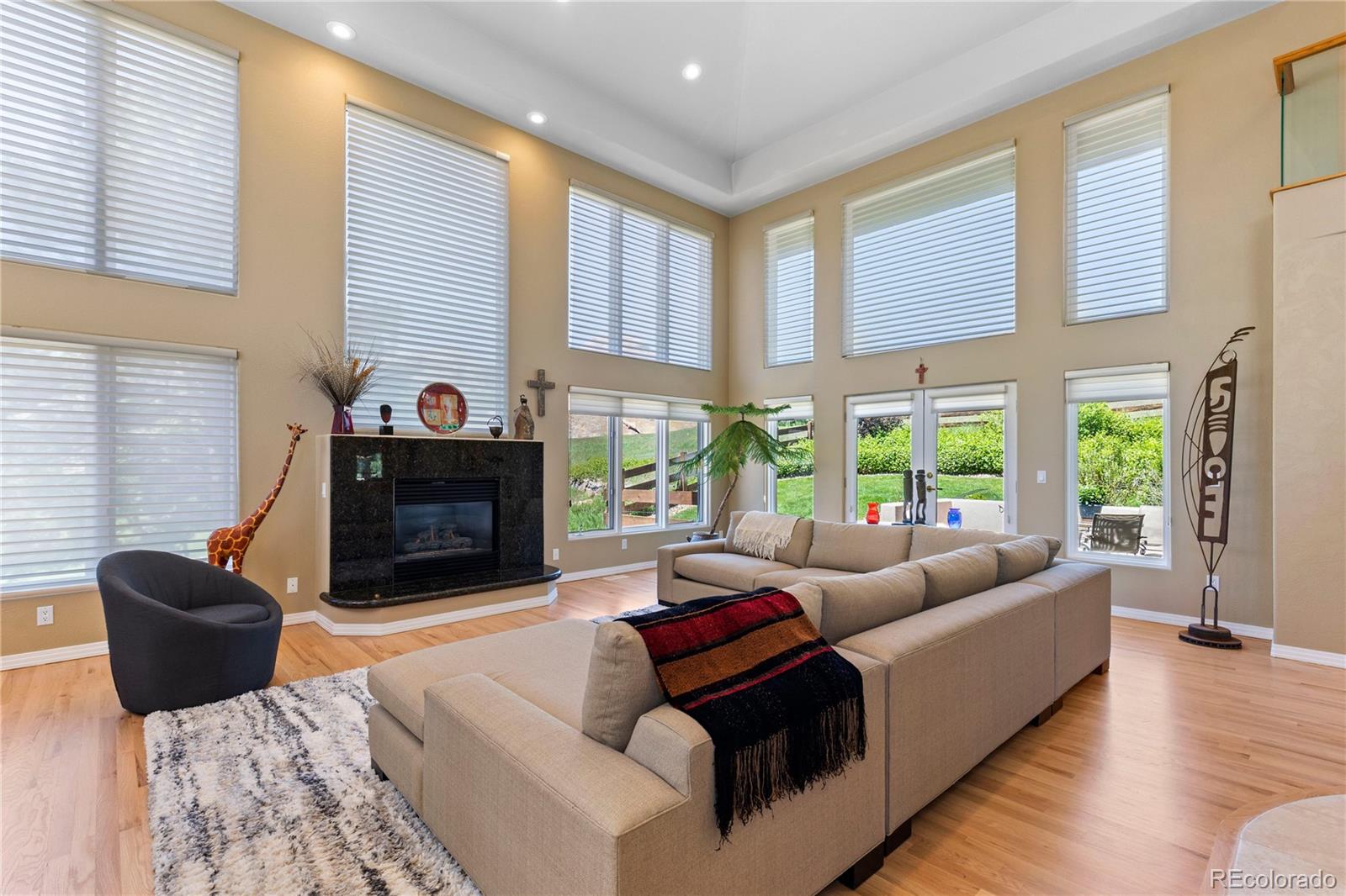 69 North Ranch Road Littleton, CO 80127 - Photo 8 of 50 a living room with fireplace furniture and a large window