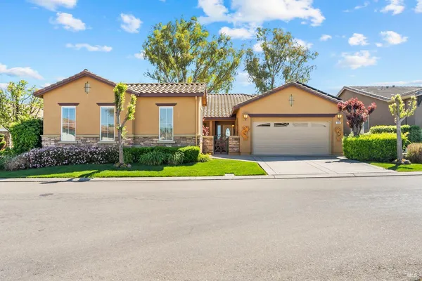 a front view of a house with a yard and garage
