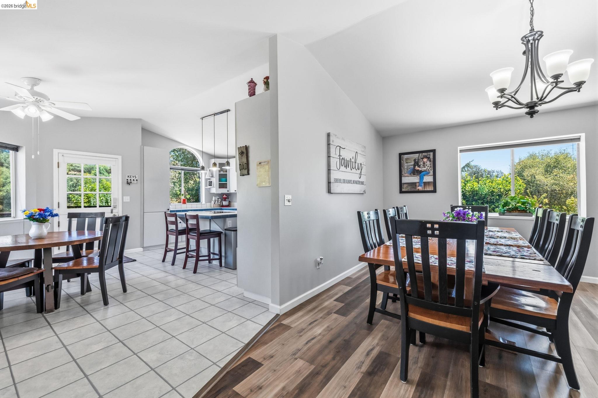 18570 Pradera Real Road Sonora, CA 95370 - Photo 39 of 66 Vaulted ceilings, a contemporary chandelier, a kitchen pass-through with multiple windows providing abundant natural lighting