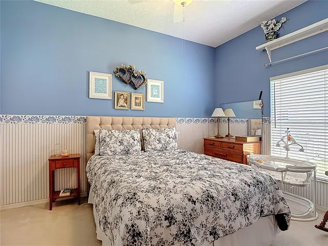 a living room with furniture kitchen view and a wooden floor
