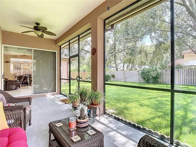 a living room with furniture and a floor to ceiling window