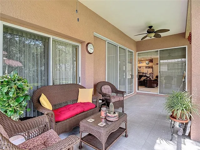 a view of a house with backyard and sitting area