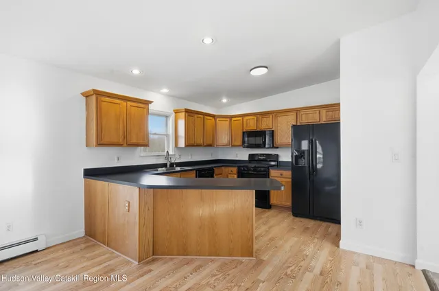 a kitchen with granite countertop cabinets sink and window
