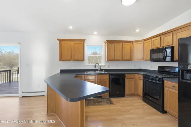 a kitchen with stainless steel appliances kitchen island granite countertop a stove and a sink