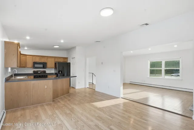 a kitchen with granite countertop a sink and cabinets