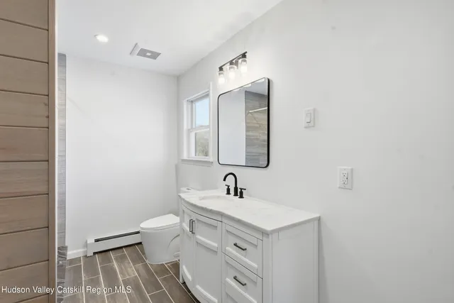 a bedroom with a bed and window with chair