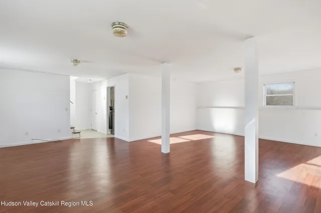 an empty room with wooden floor