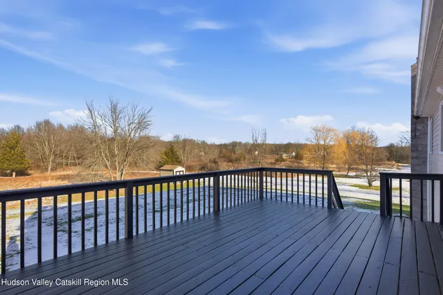 a view of balcony with wooden floor