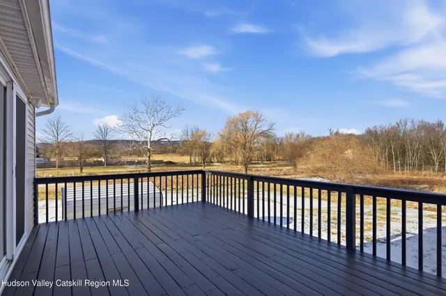 a view of a yard with wooden fence