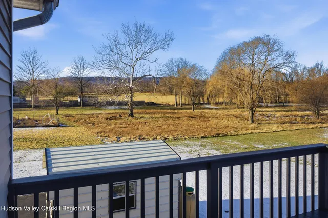 a view of yard with swimming pool and trees in the background