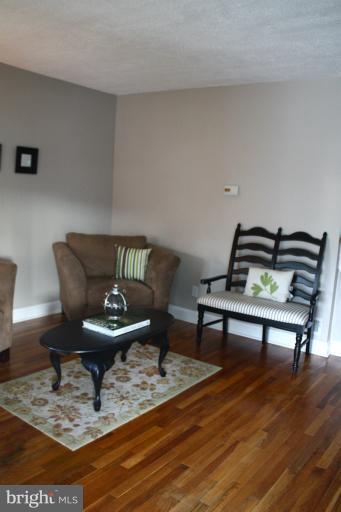 749 Arncliffe Road Baltimore, MD 21221 - Photo 12 of 20 a living room with furniture and a chair