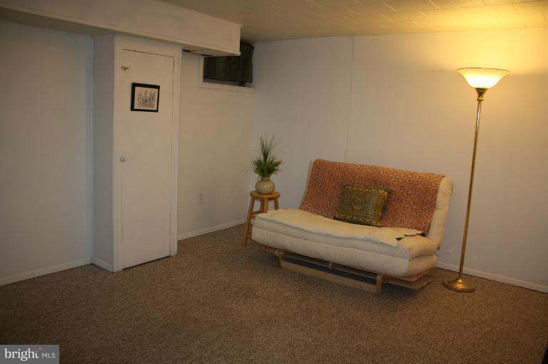 749 Arncliffe Road Baltimore, MD 21221 - Photo 16 of 20 a white couch sitting in a room