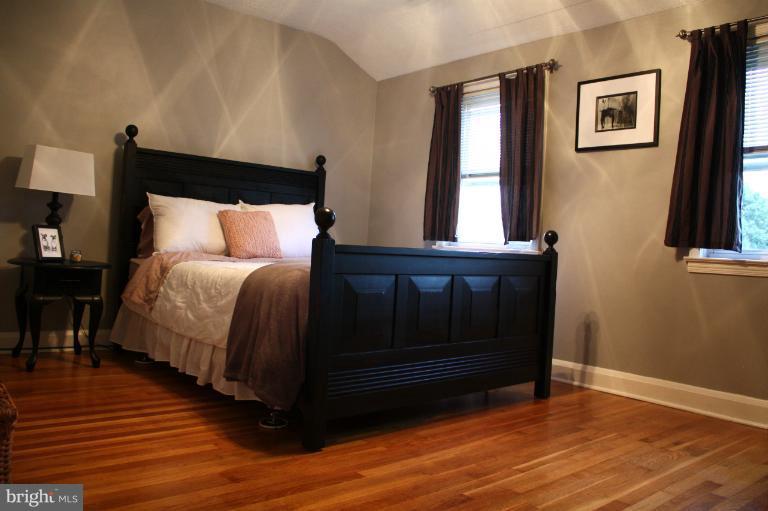 749 Arncliffe Road Baltimore, MD 21221 - Photo 17 of 20 a bedroom with a bed and wooden floor