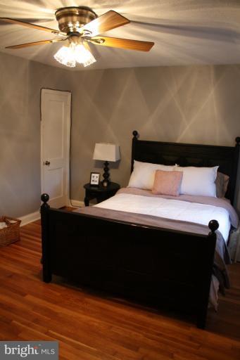 749 Arncliffe Road Baltimore, MD 21221 - Photo 4 of 20 a bed sitting in a bedroom next to a lamp
