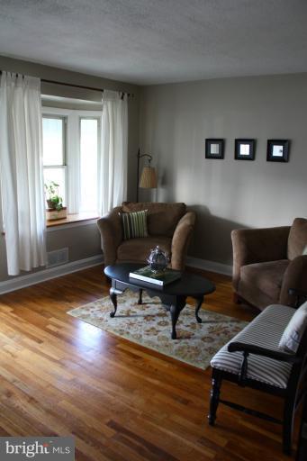 749 Arncliffe Road Baltimore, MD 21221 - Photo 5 of 20 a living room with furniture and a wooden floor
