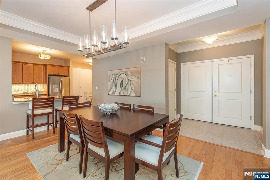 6105 Harcourt Road Clifton, NJ 07013 - Photo 14 of 23 a dining room with furniture a chandelier and wooden floor