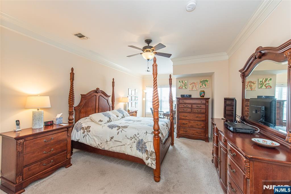 6105 Harcourt Road Clifton, NJ 07013 - Photo 15 of 23 a bedroom with a bed and a flat tv screen on the dresser