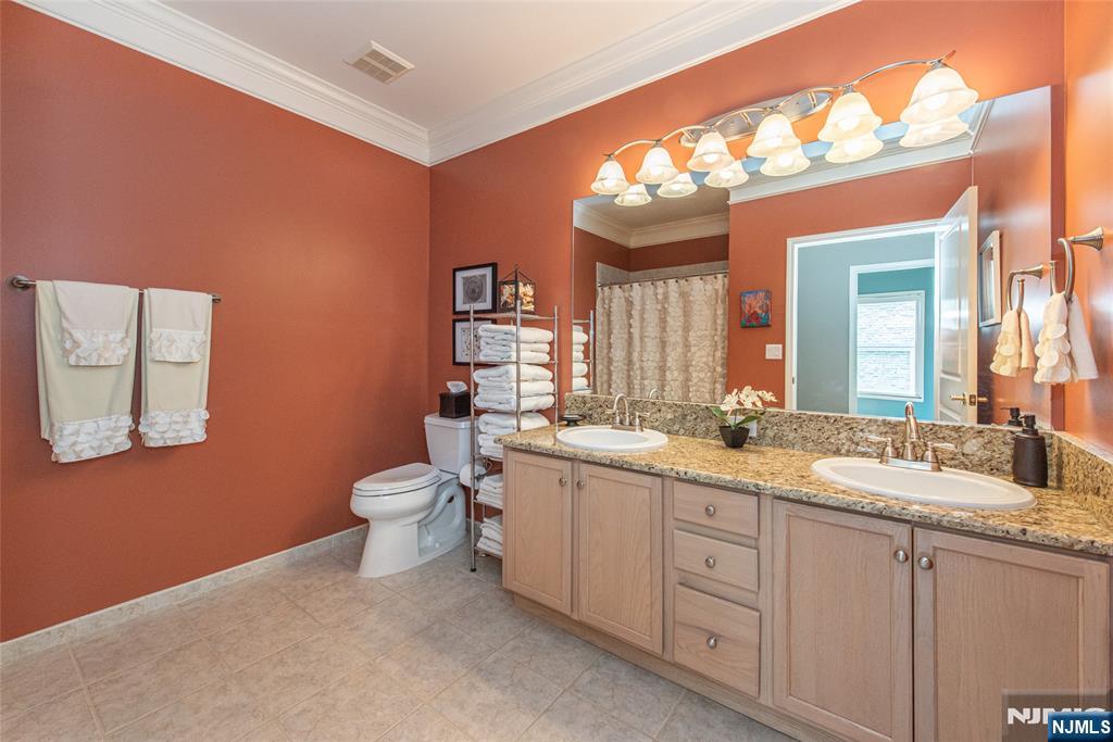 6105 Harcourt Road Clifton, NJ 07013 - Photo 17 of 23 a bathroom with a double vanity sink and a mirror