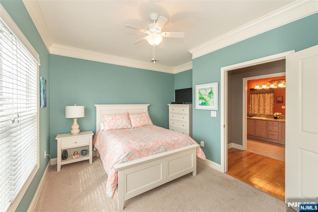 6105 Harcourt Road Clifton, NJ 07013 - Photo 19 of 23 a bedroom with a large bed and a chandelier