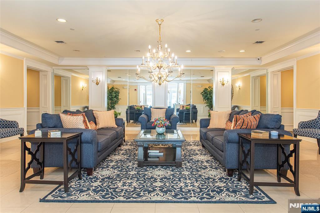 6105 Harcourt Road Clifton, NJ 07013 - Photo 2 of 23 a living room with furniture a rug and a chandelier