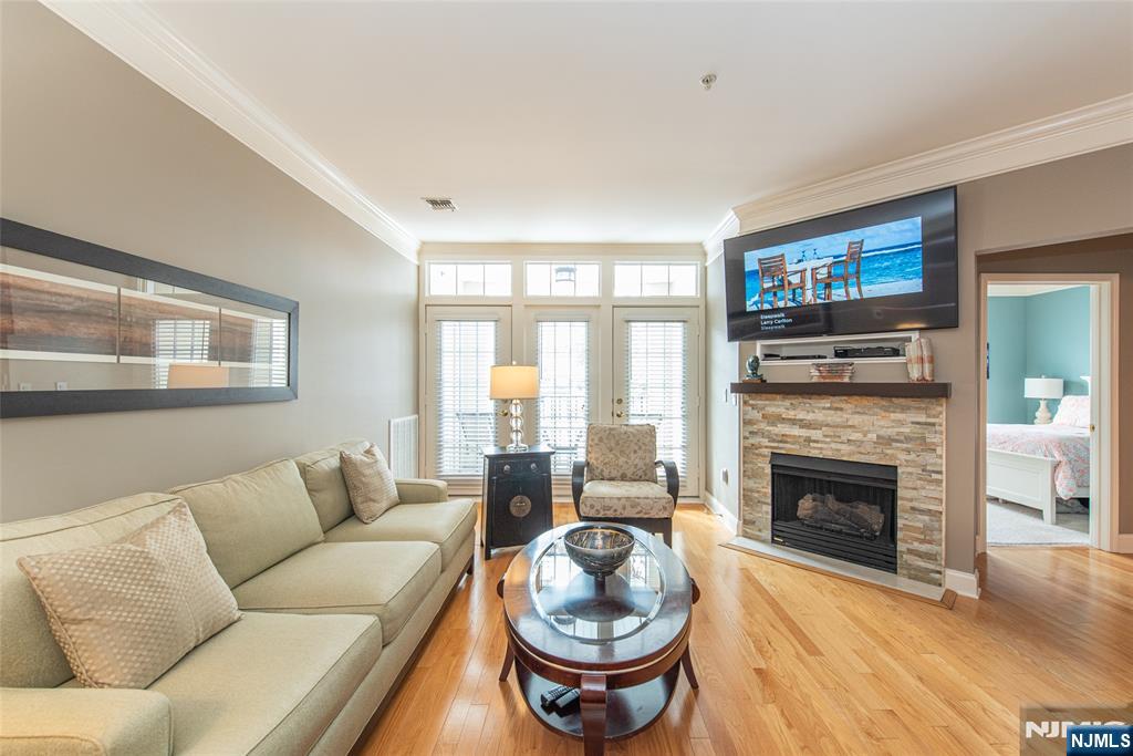 6105 Harcourt Road Clifton, NJ 07013 - Photo 4 of 23 a living room with furniture a fireplace and a flat screen tv