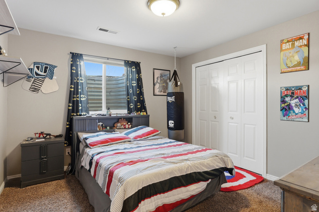 114 North Clark Lane Elk Ridge, UT 84651 - Photo 21 of 26 Bedroom featuring a window with privacy screening, neutral wall paint, and textured carpeting
