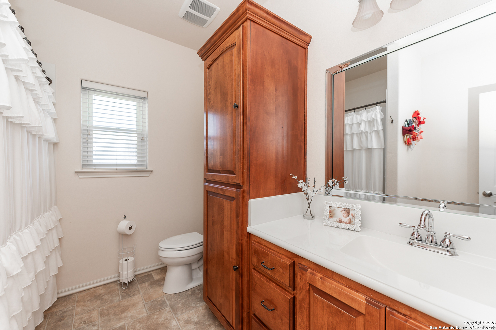 511 County Road 423 D'Hanis, TX 78850 - Photo 25 of 47 a bathroom with a sink a toilet and a mirror
