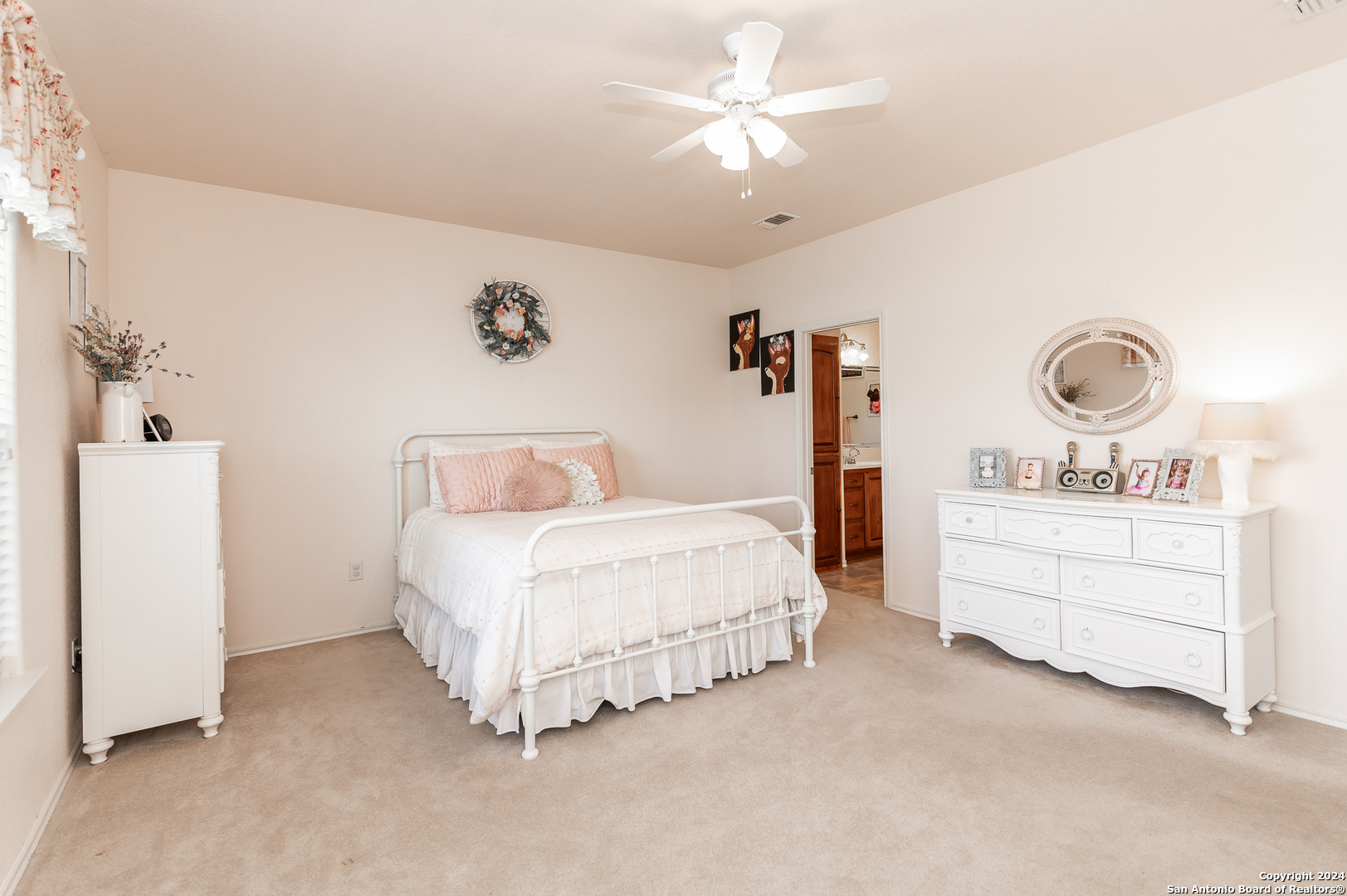 511 County Road 423 D'Hanis, TX 78850 - Photo 26 of 47 a spacious bedroom with a bed and a chandelier