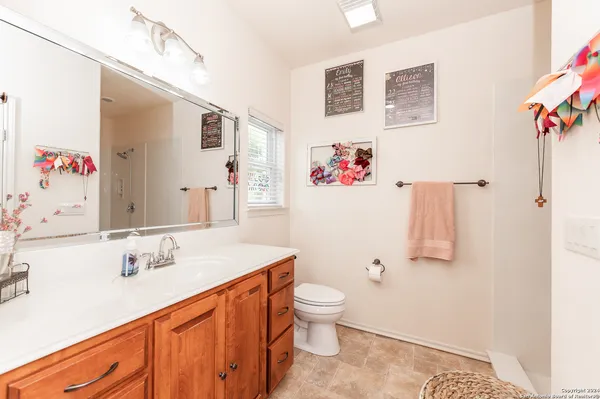 a bathroom with a sink vanity and toilet