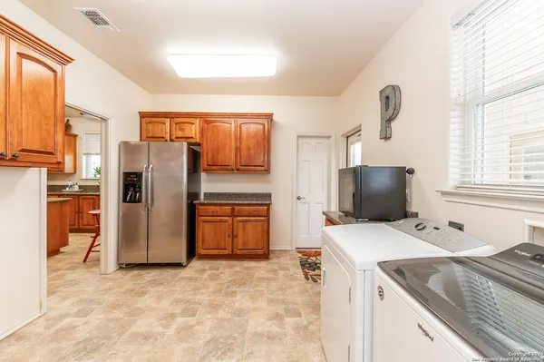 a kitchen that has a refrigerator and a sink