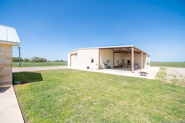 a backyard of a house with lots of green space and plants