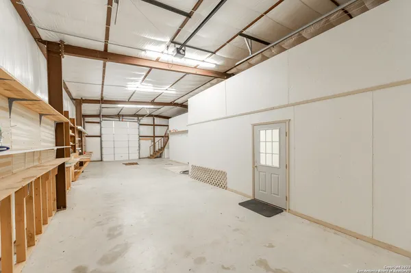 a view of empty room with wooden walls