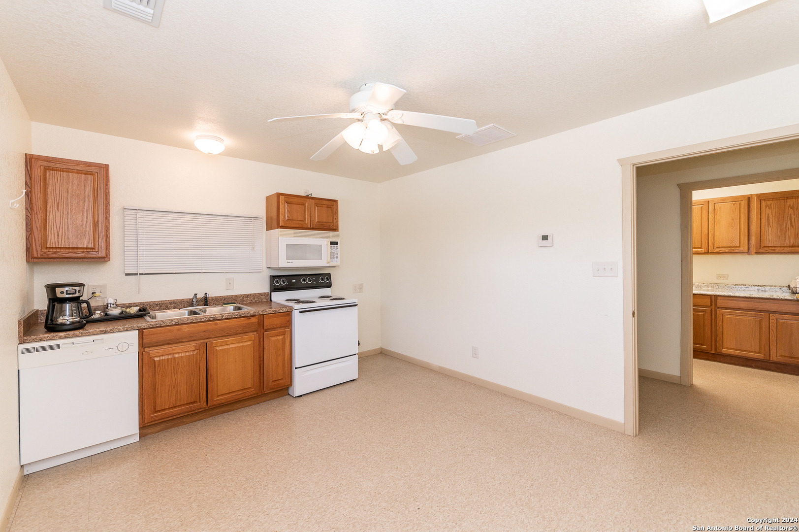 511 County Road 423 D'Hanis, TX 78850 - Photo 42 of 47 a kitchen with stainless steel appliances granite countertop a stove a sink and a refrigerator